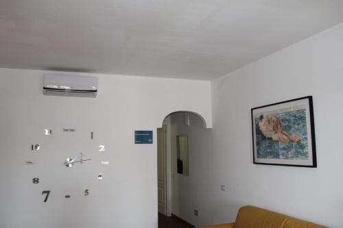 a room with white walls and a picture on the wall at Appartamento Le Vele in Porto San Paolo