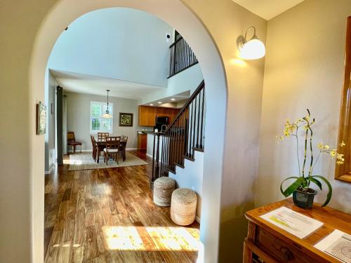 an archway leads into a living room and dining room at Summer Special! Hilton Pool Pass included! in Waikoloa