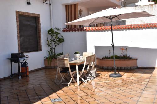 a table and chairs with an umbrella on a patio at SIERRA LAGO in Córdoba