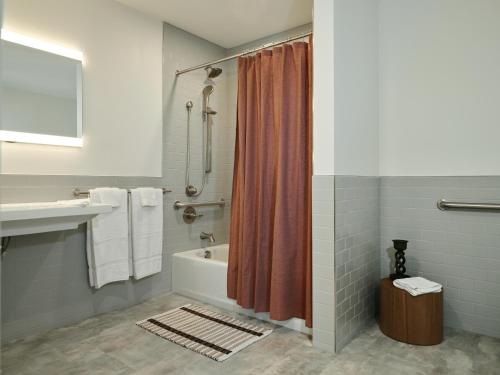 a bathroom with a tub and a shower curtain at Tomorrow Building at Somer Station in Chattanooga