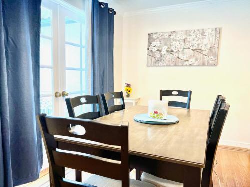 a dining room table with chairs and a plate of food on it at 3 bedroom residential home in the lovely town near SFO San Francisco in Millbrae