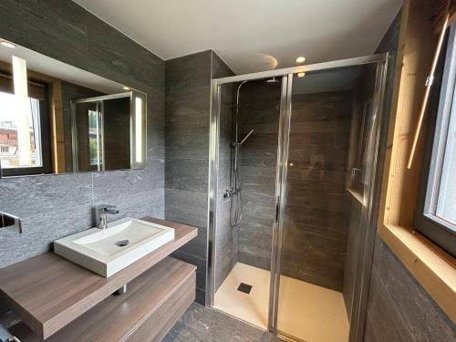 une salle de bain avec un lavabo et une douche dans l'établissement Appartement neuf aux Gets, au pied des pistes et du centre, avec terrasse et services inclus - FR-1-623-50, aux Gets