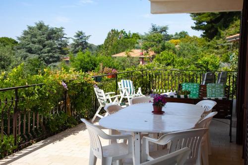 a white table and chairs on a patio at MAGIA & EMOZIONI - Trecastagni- Area etnea Villa vista mare in Trecastagni