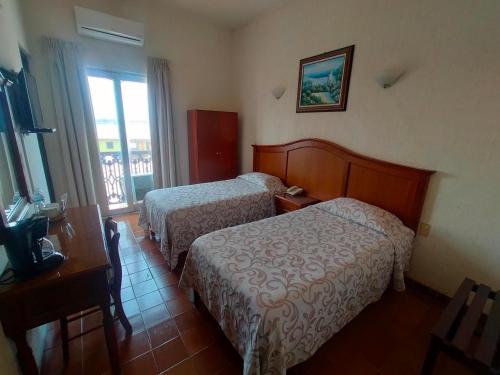 Hotel Posada Doña Lalaにあるベッド