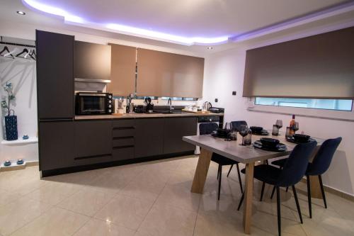 a kitchen with a table and chairs in a room at Black Suites in Chania
