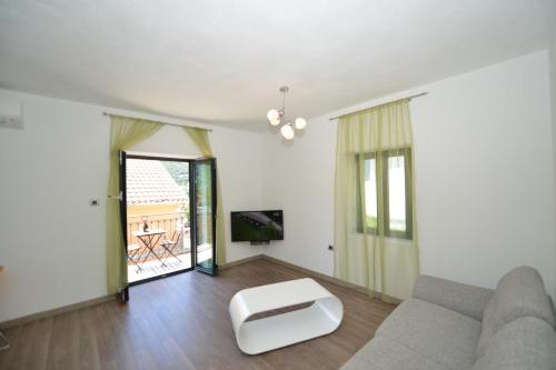 a living room with a couch and a table at Apartments Windrose in Kotor