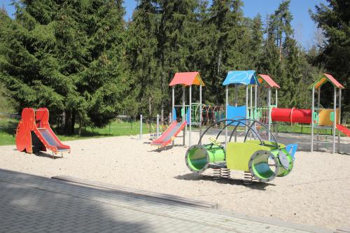 a playground with colorful playground equipment in a park at Chata Demian in Demanovska Dolina