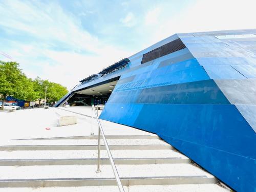 a blue building with stairs in front of it at APSTAY Eggenberg I Self Check-in I Parking option in Graz
