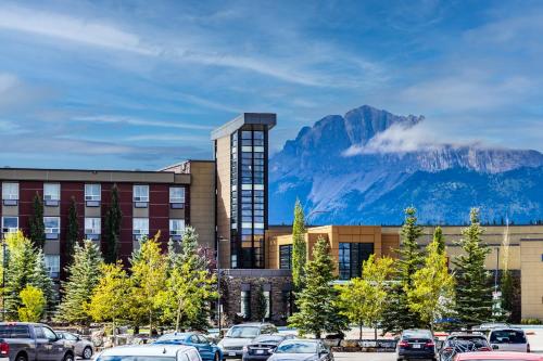 a parking lot with a building with a mountain in the background at Stoney Nakoda Resort & Casino in Seebe