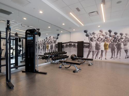 a gym with exercise equipment and a mural of gymnasts at Hotel Indigo - Panama City Marina by IHG in Panama City