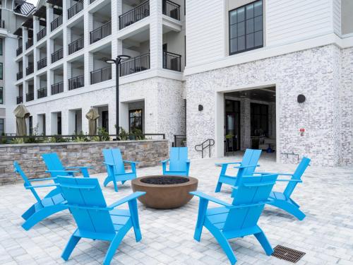 a group of blue chairs in front of a building at Hotel Indigo - Panama City Marina by IHG in Panama City