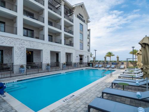 a swimming pool in front of a hotel at Hotel Indigo - Panama City Marina by IHG in Panama City