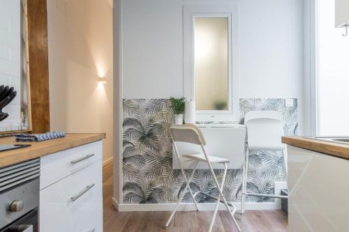 uma cozinha com uma mesa e duas cadeiras em Modern and cozy- 1 Bedroom 1 Bathroom -Lavapiés em Madri