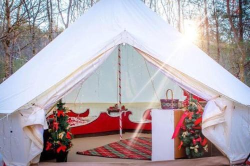 a white tent with a table and christmas decorations at Candy Cane Glamp Yurt in the Woods in Columbia