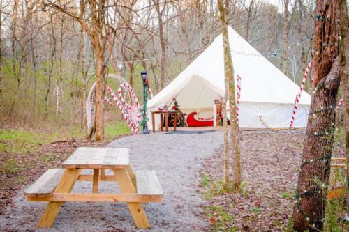 a tent with a picnic table in front of it at Candy Cane Glamp Yurt in the Woods in Columbia