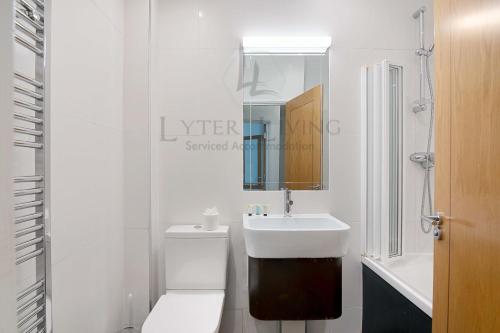 a white bathroom with a toilet and a sink at The Wharf - Oxford City Centre with Garden at Lyter Living Serviced Accommodation Oxford in Oxford