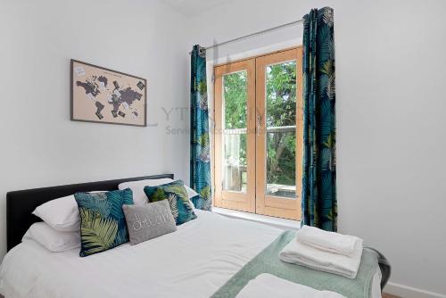 Schlafzimmer mit einem Bett und einem Fenster in der Unterkunft The Wharf - Oxford City Centre with Garden at Lyter Living Serviced Accommodation Oxford in Oxford