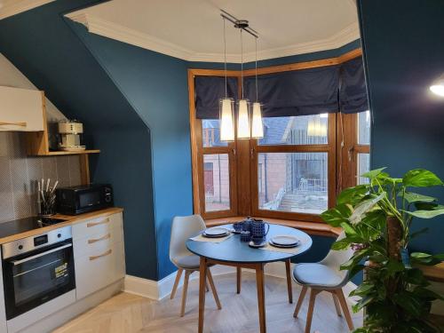 a kitchen with a table and chairs and a window at Trinity apartments n56 in Peterhead