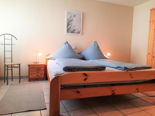 a bedroom with a bed with blue pillows at Apartment In Spay Smile Zell-Merl Mosel in Zell an der Mosel