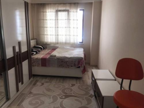 a small bedroom with a bed and a window at Relaxable Apartment in Eyüp sultan in Istanbul