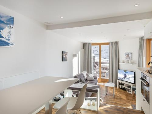 un soggiorno bianco con tavolo e sedie di Appartement Val Thorens, 3 pièces, 6 personnes - FR-1-640-23 a Val Thorens