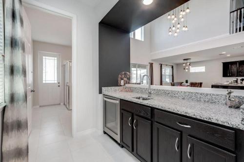 a kitchen with a sink and a large mirror at BSV1529 - Luxury 7 Bedroom 5 Bathroom Villa in the Desirable Solara Resort in Kissimmee