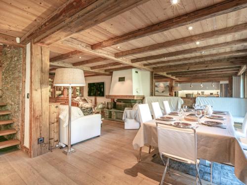 une salle à manger avec une table et des chaises blanches dans l'établissement Cocon raffiné 5 pièces skis aux pieds à Val-d’Isère avec wifi, cheminée et garage - FR-1-694-11, à Val dʼIsère