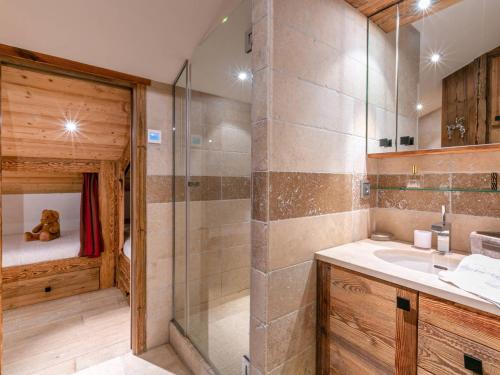 a bathroom with a sink and a shower with a teddy bear at Appartement Val-d'Isère, 5 pièces, 8 personnes - FR-1-694-11 in Val-d'Isère