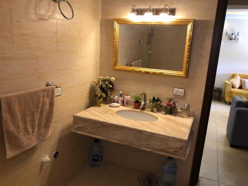 a bathroom with a sink and a mirror at قرية ماليبو / العين السخنة in Ain Sokhna