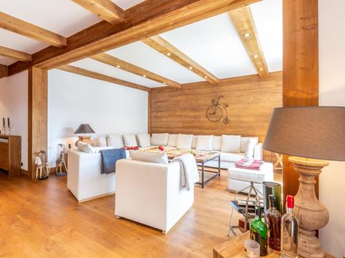 Elle comprend un salon doté d'un mobilier blanc et de plafonds en bois. dans l'établissement Luxueux 4 pièces avec alcove, superbe séjour, prestations haut de gamme, au cœur de Val-d'Isère - FR-1-694-167, à Val dʼIsère