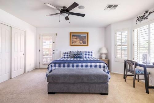 a bedroom with a bed and a ceiling fan at AZ Sun Palm Retreat w/optional Private Heated Pool in Surprise