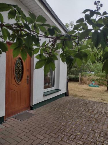 uma casa com uma porta castanha e uma janela em Agroturystyka em Kosarzyn