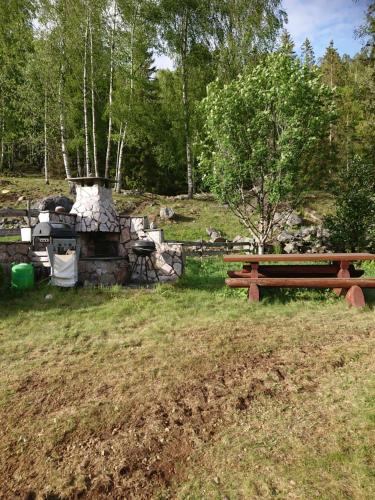 a picnic table and a bench in a park at Marken in Hjartdal