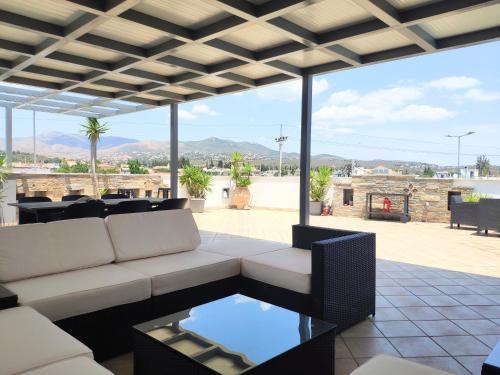 a living room with a couch and a table at #Roof(pool)garden Private in Pikérmion