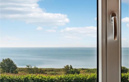a view of the ocean from a window at Amazing Home In Vesløs in Øsløs