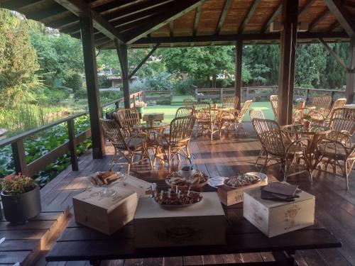 a deck with chairs and tables and boxes on it at Parc Hotel Casa Mia in Lazise