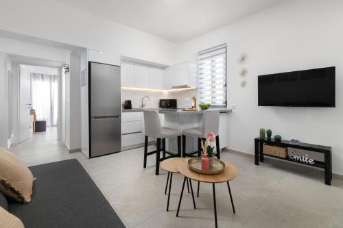 a living room with a kitchen with a counter and a table at Rhodes city studios in Rhodes Town