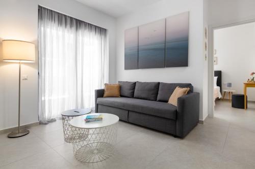 a living room with a couch and a table at Rhodes city studios in Rhodes Town