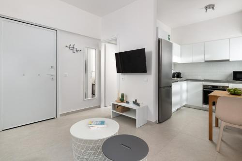 a living room with a kitchen and a table at Rhodes city studios in Rhodes Town