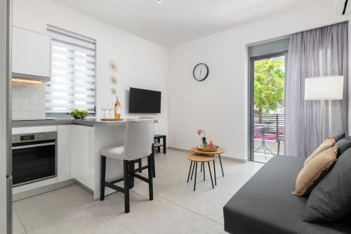 a kitchen and living room with a table and a couch at Rhodes city studios in Rhodes Town