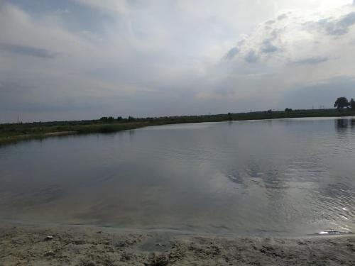 a large body of water on a cloudy day at Family & Relax Loft Lake House in Zagalʼtsy
