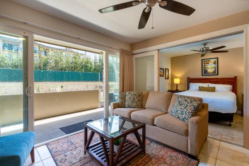 a living room with a bed and a couch at 2 Bedroom Kapaa Condo, Pool, AC, Beach Access KK116 in Kapaa