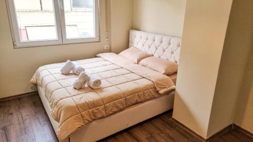 - une chambre avec un lit et des serviettes dans l'établissement New Bazaar 1BD Modern Apartment, à Tirana