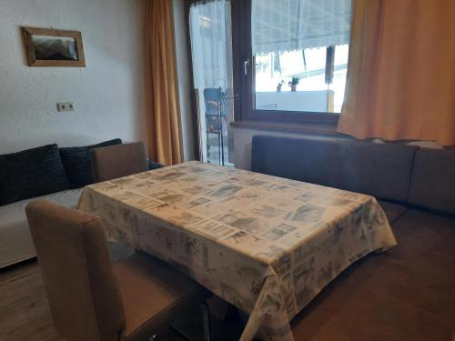 a table with a table cloth on it in a room at Ferienwohnung Schiestl in Zell am Ziller