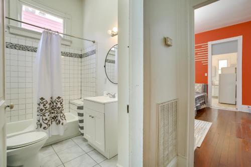 a bathroom with a toilet and a tub and a sink at New Orleans Home Near Fair Grounds and City Park! in New Orleans