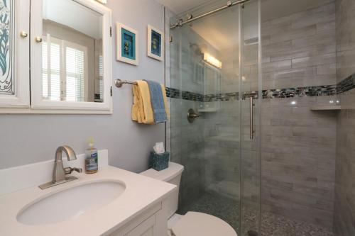 a bathroom with a sink and a glass shower at Creston House 6E in St. Augustine