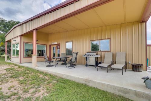 a patio with chairs and a table on a house at Bertram Ranch Property with Patio and Gas Grill! in Bertram