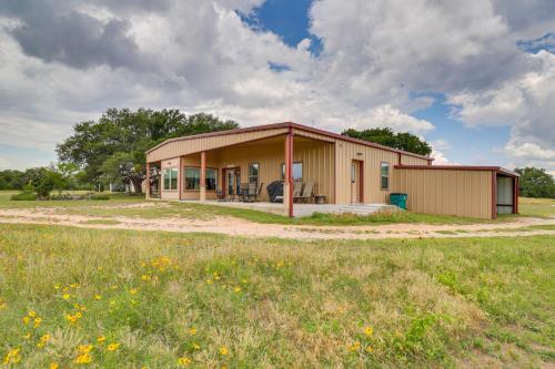 a small building with a field in front of it at Bertram Ranch Property with Patio and Gas Grill! in Bertram