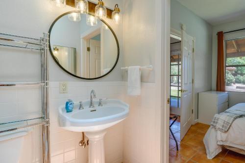 a bathroom with a sink and a mirror at Eloy Vacation Rental with Pool Access and Courtyard! in Eloy