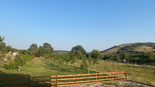 a fence in a field with a hill in the background at HEAVEN HOUSE in Kavala